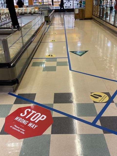 Grocery store floor with tape and decals on it