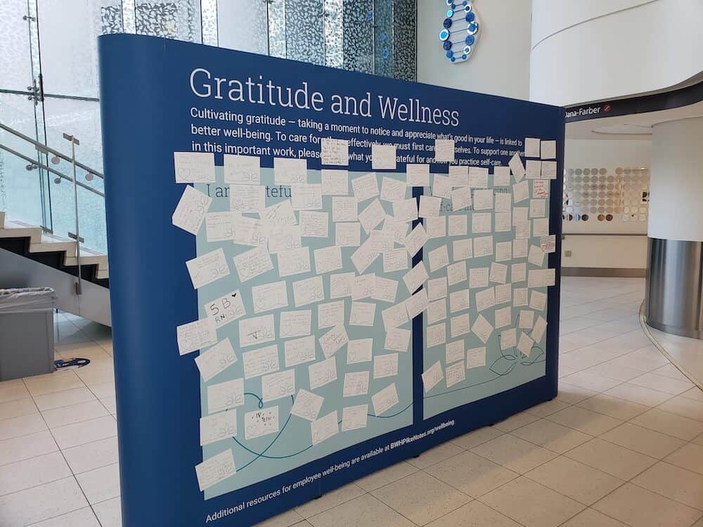Blue display with white sticky notes with positive messages