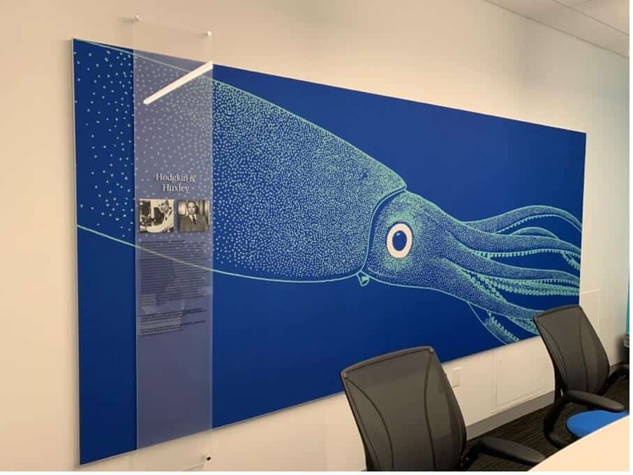 A mural of a blue squid on a white wall