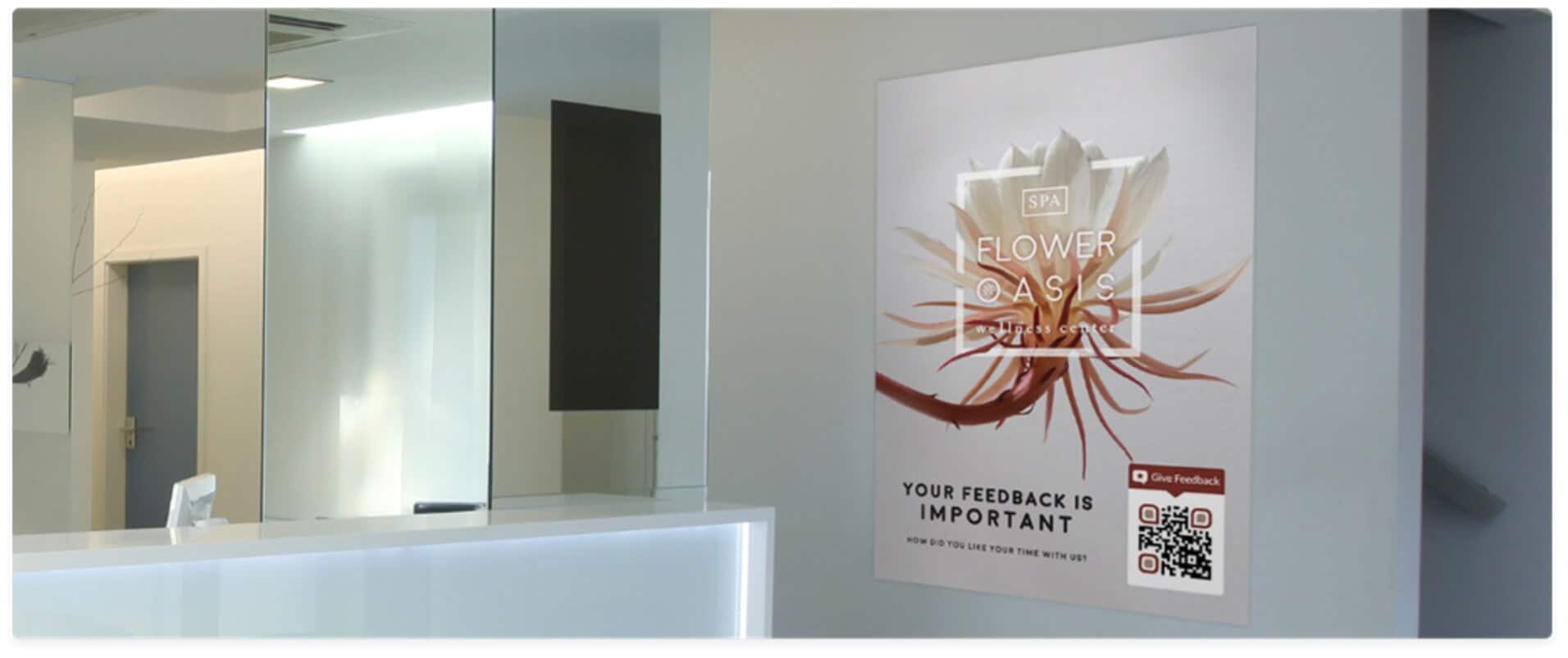 A hotel reception area featuring a poster requesting guest feedback.