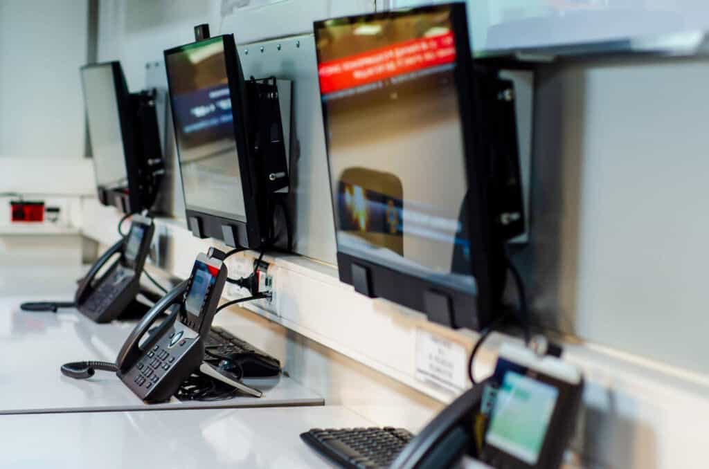 phones lined up on desk at an emergency response center